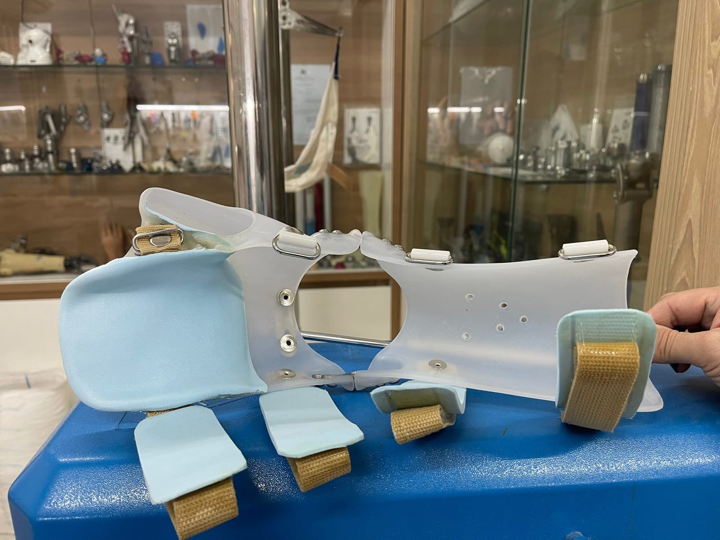 A foot–lower-leg orthosis photographed during fabrication: it wraps the shank and foot and holds the ankle in a good position.